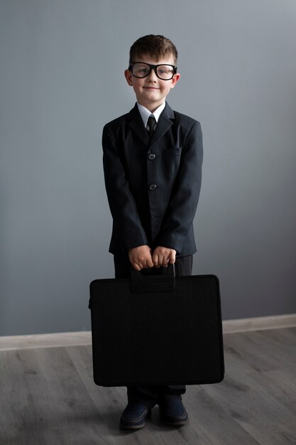 Portrait of cute child with suit and briefcase