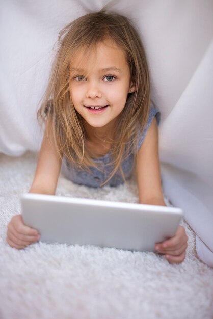 Portrait of cute girl holding a digital tablet