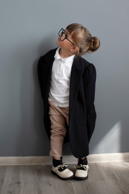 Free Photo portrait of cute girl in oversized coat and glasses