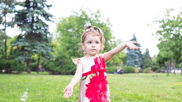 Portrait of cute girl standing in the garden