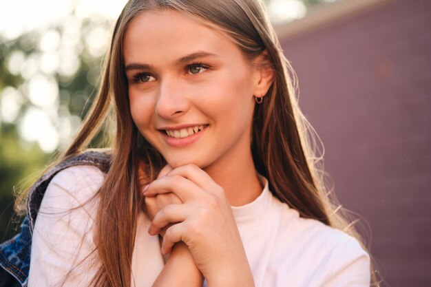 Portrait of cute smiling casual girl joyfully looking away outdoor