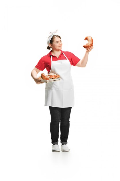 Portrait of cute smiling woman with pastries in her hands