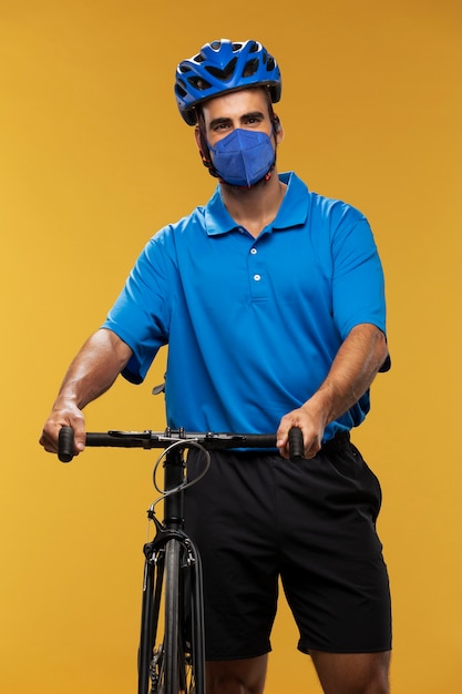 Free photo portrait of delivery man with bicycle and backpack