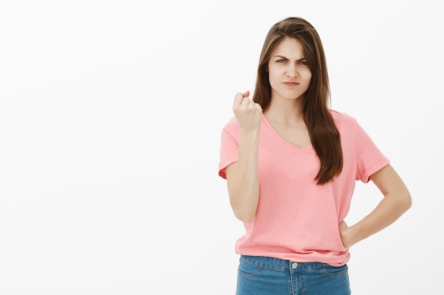 Portrait of disappointed brunette woman posing in the studio