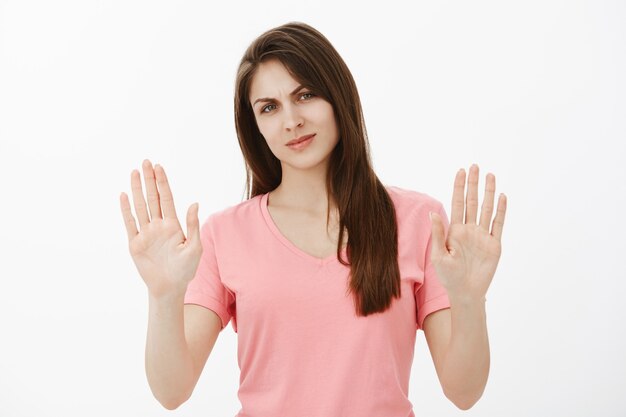 Portrait of displeased brunette woman posing in the studio