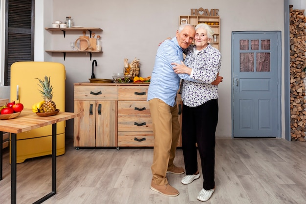 Portrait of elderly couple hugging