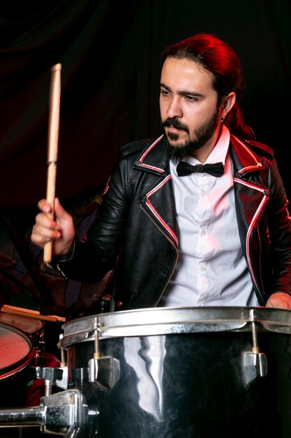 Portrait of elegant man playing drums