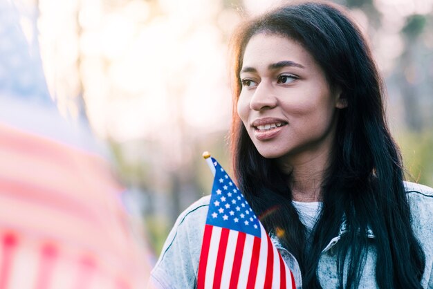 Portrait of ethnic American woman with flag