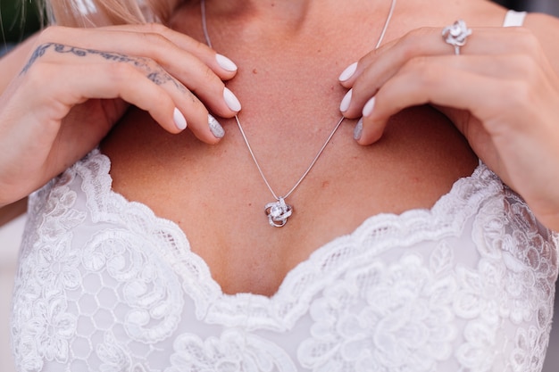 Free photo portrait of european woman in wedding dress wearing necklace and ring.