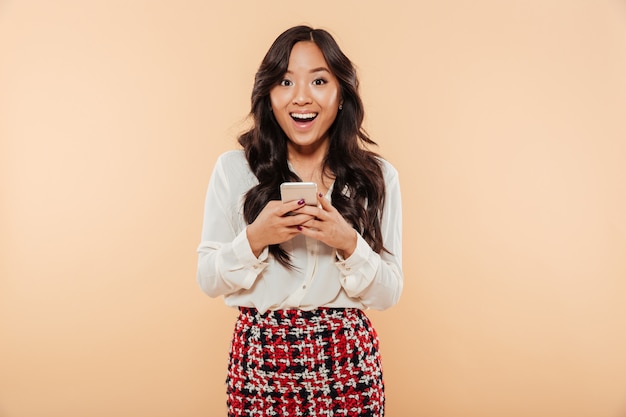 Portrait of an excited asian woman