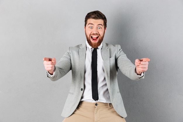 Portrait of an excited businessman dressed in suit standing