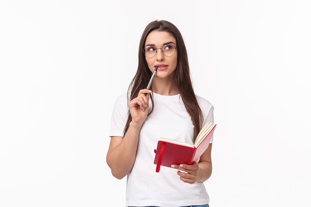 portrait expressive young woman holding notebook