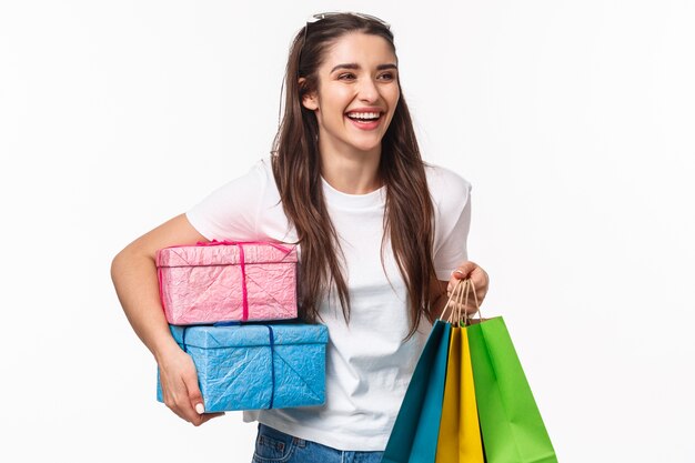 Free photo portrait expressive young woman holding shopping bags