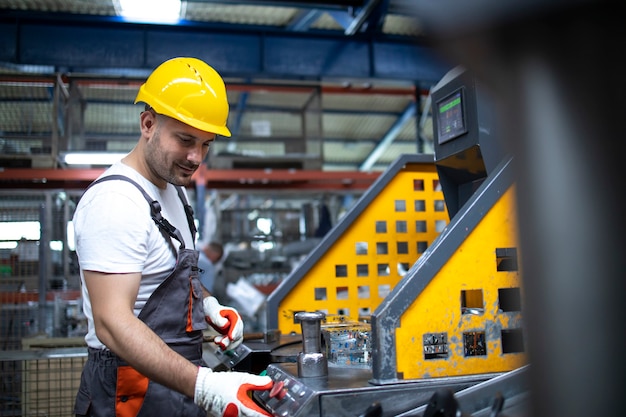 Free photo portrait of factory worker working on industrial machine in production plant