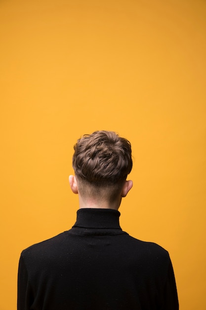 Free photo portrait of fashionable boy from behind