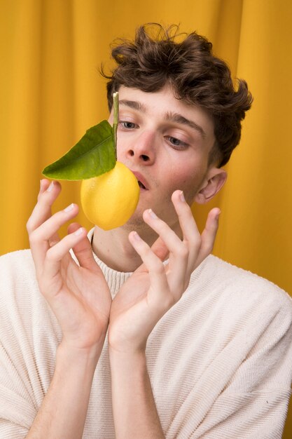 Portrait of fashionable boy with lemon