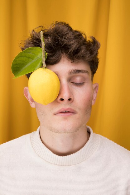 Portrait of fashionable boy with lemon