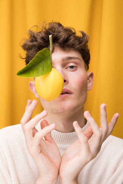 Portrait of fashionable boy with lemon