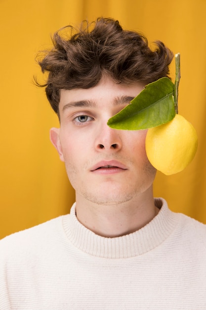 Portrait of fashionable boy with lemon