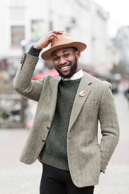 Portrait of fashionable man smiling outside