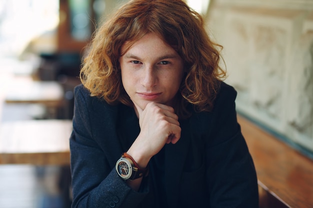 Portrait of fashionable reddish young man posing