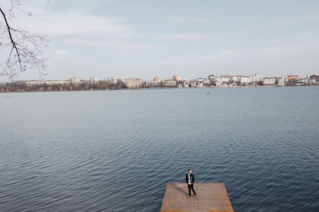 Free photo portrait of fashionable well dressed man with beard posing outdoors