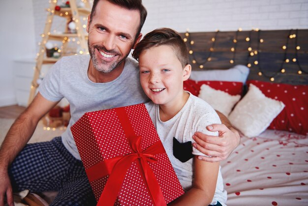 Portrait of father and som with christmas present