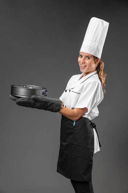 Portrait female chef with pan