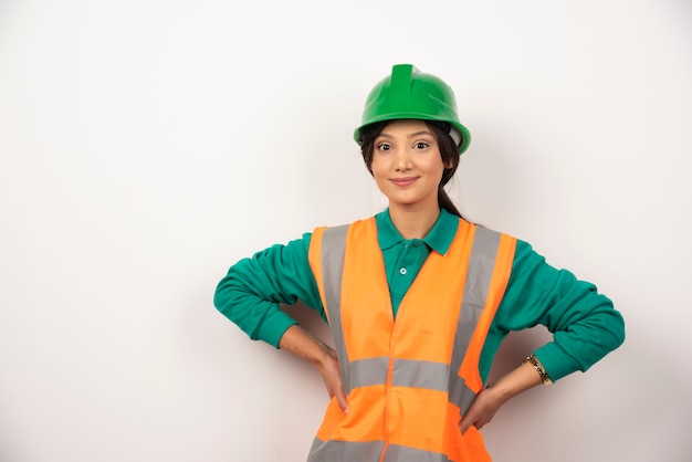 Portrait of female construction worker on white background.