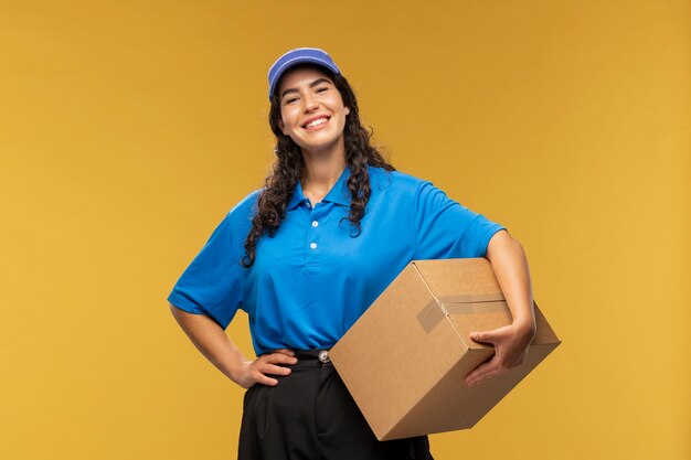 Portrait of female deliverer holding parcel