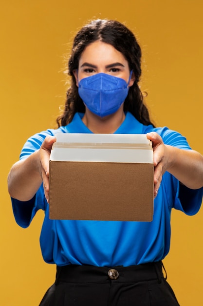 Portrait of female deliverer with medical mask on