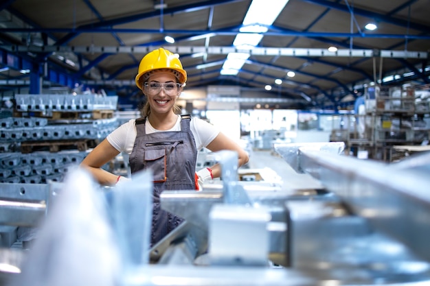 Free photo portrait of female factory worker standing in production hall