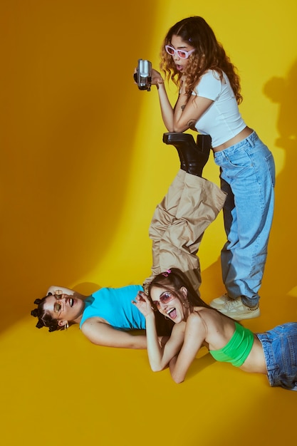 Free photo portrait of female friends in 2000s fashion style posing together with camera