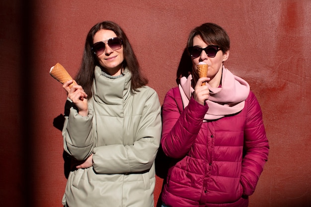 Free photo portrait of female friends outdoors with ice cream cones