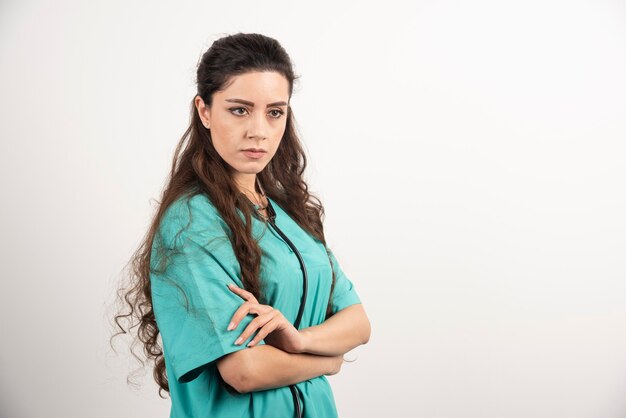 Portrait of female healthcare worker posing with crossed hands.