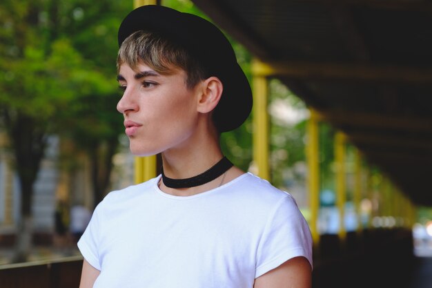 Portrait of female hipster with natural makeup and short haircut enjoying leisure time outdoors