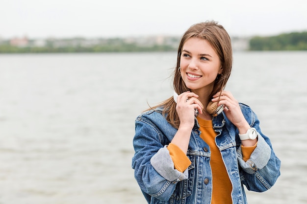 Free photo portrait female with headphones outdoor