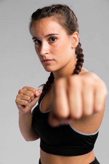 Portrait of fit woman in combat position