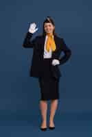 Free photo portrait of flight attendant waving