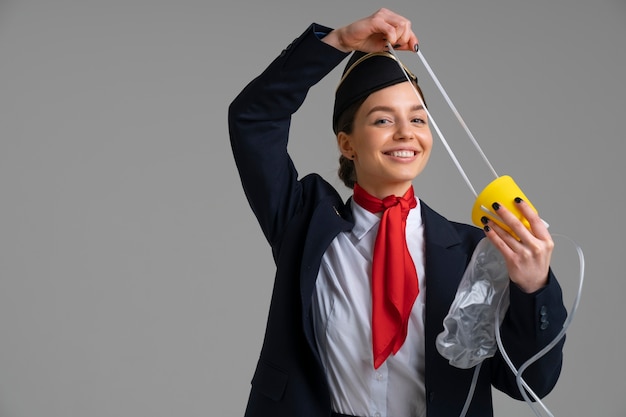 Free photo portrait of flight attendant with oxygen mask