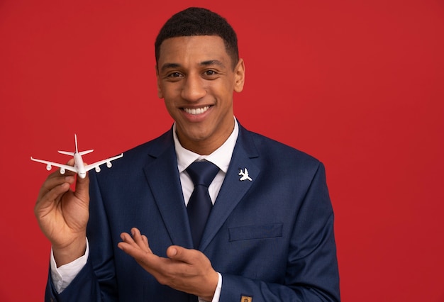 Free photo portrait of flight attendant with plane figurine