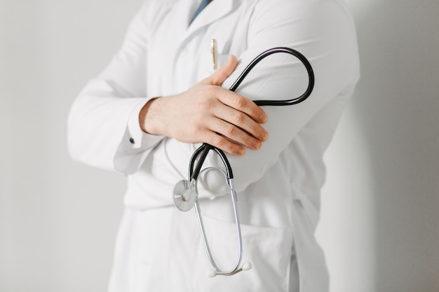 Free photo portrait of a friendly doctor isolated on gray