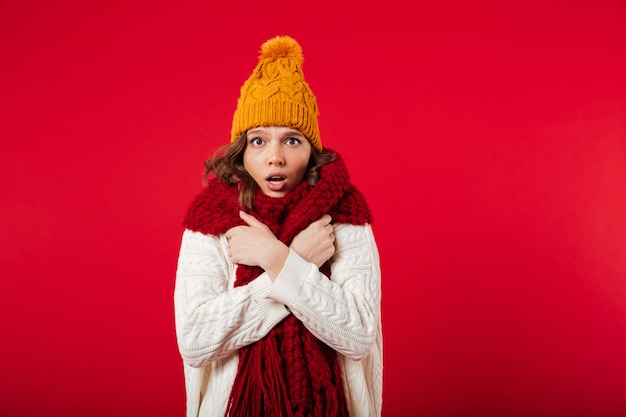 Portrait of a frozen girl dressed in winter hat