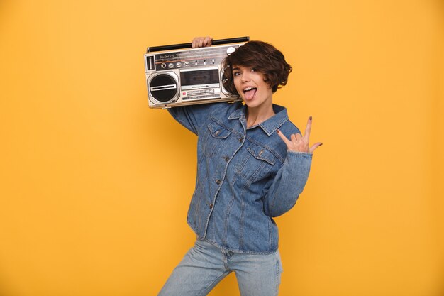 Portrait of a funny joyful woman dressed in denim jacket