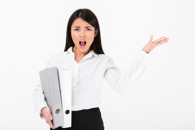 Free Photo portrait of a furious asian businesswoman holding binders