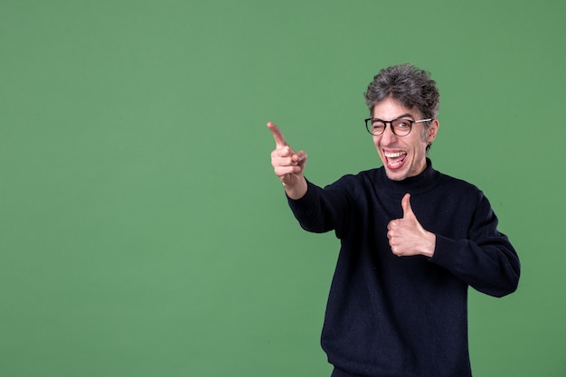 Portrait of genius man in studio shot on green wall