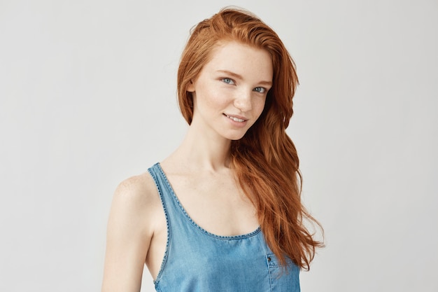 Portrait of ginger woman smiling.