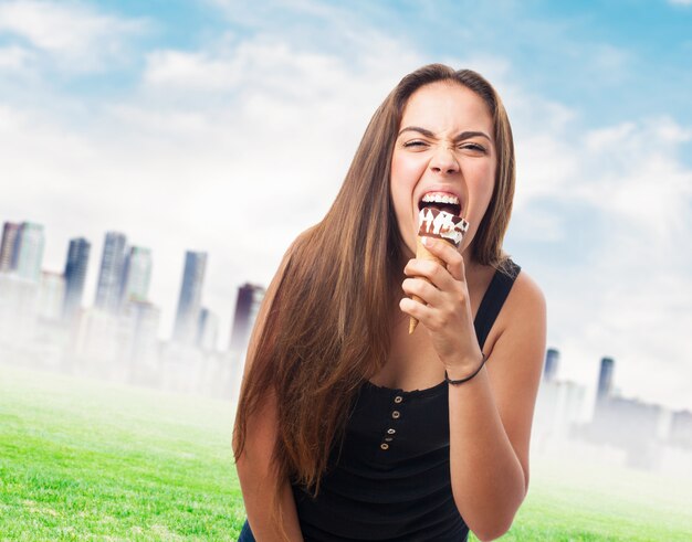 Portrait of girl biting chocolate ice cream.