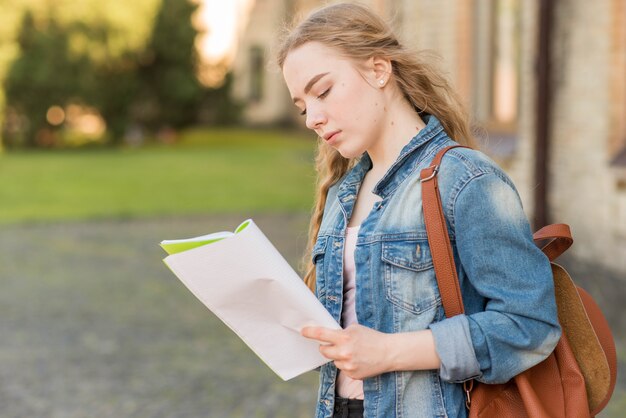 Portrait of girl in front of school