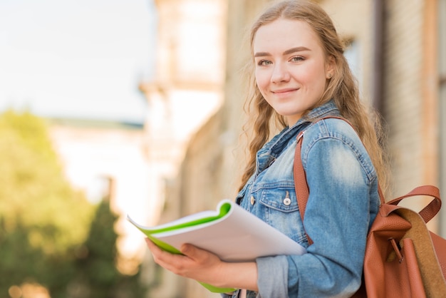 Portrait of girl in front of school